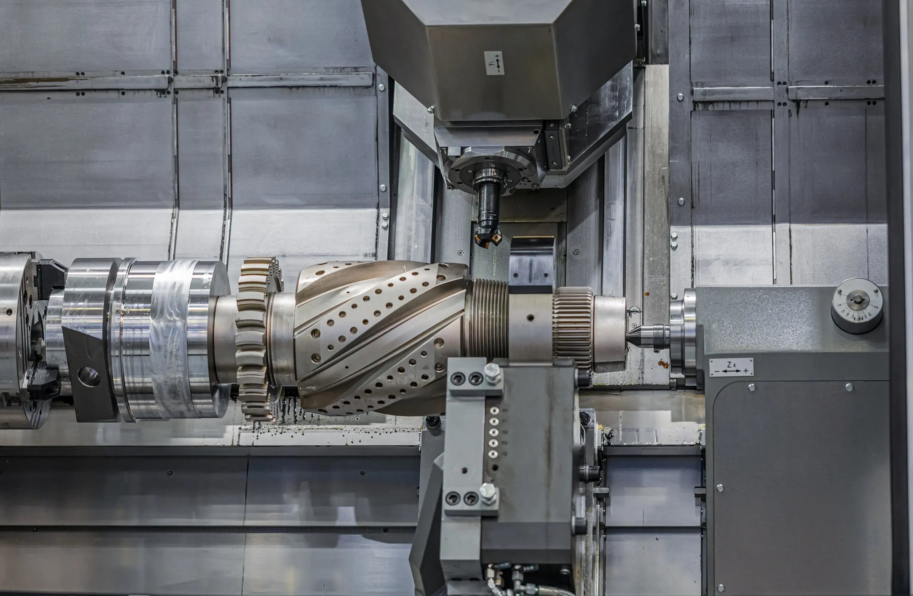 CNC turn-mill centre performing automated small-part machining with robotic loading for high-precision component production.