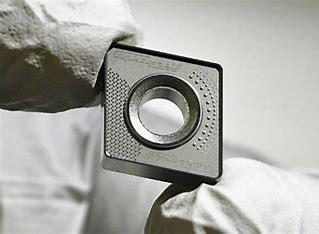 Close-up of carbide insert with fine micro-milled details produced by femtosecond laser machining.